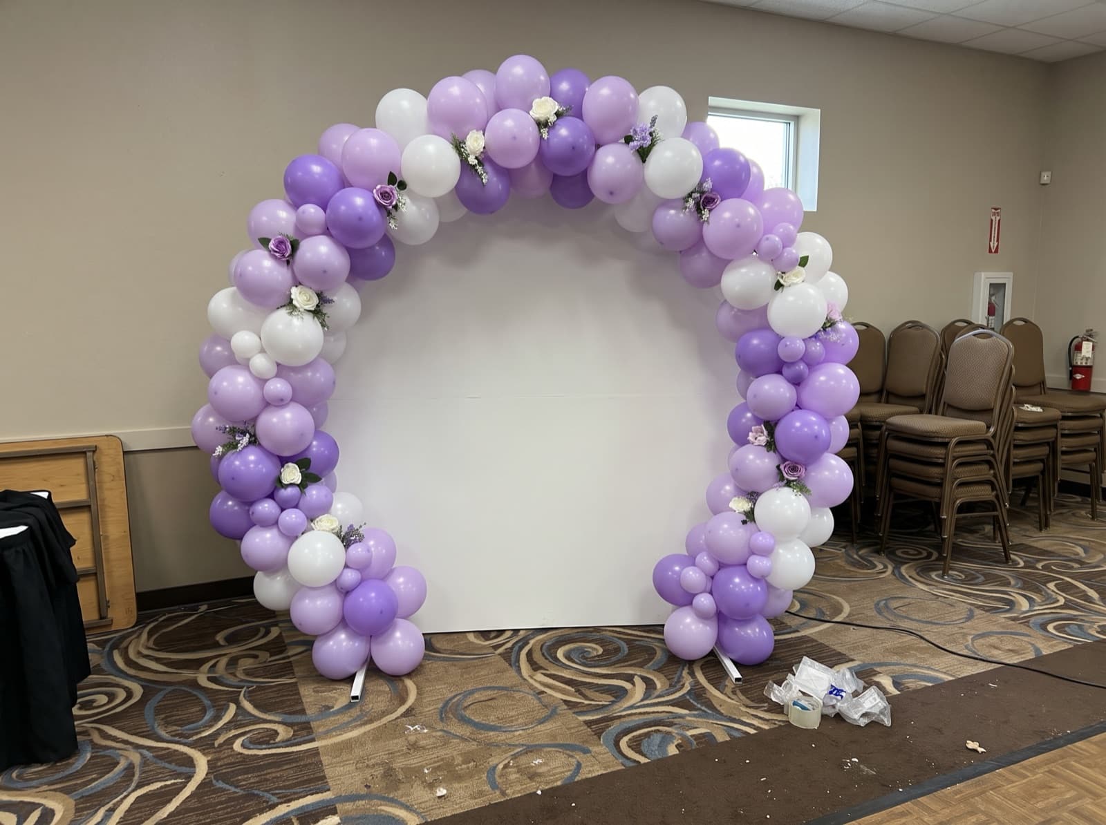 Round balloon arch framing a photo spot in a banquet hall