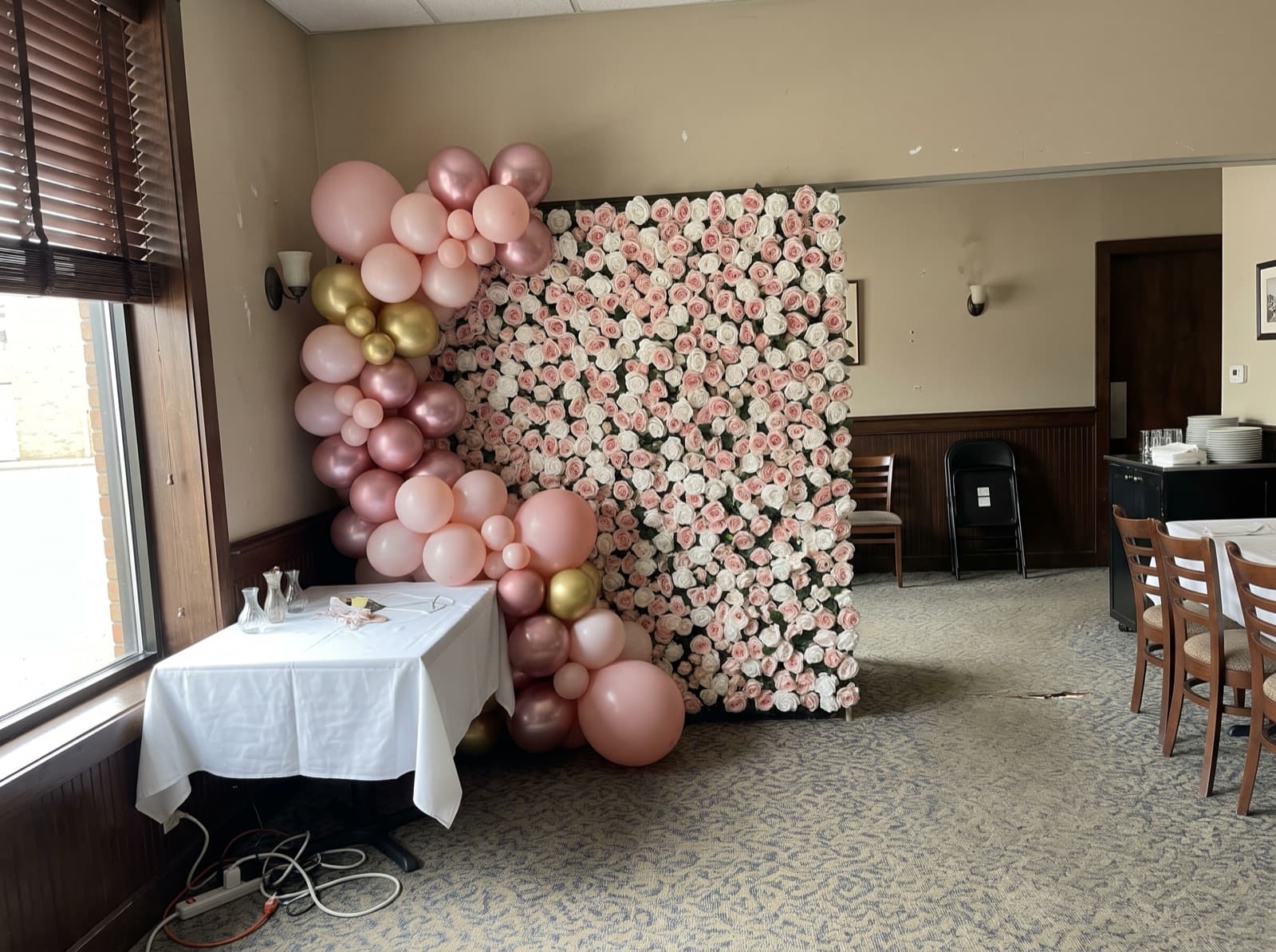 Flower wall backdrop with a blush balloon garland