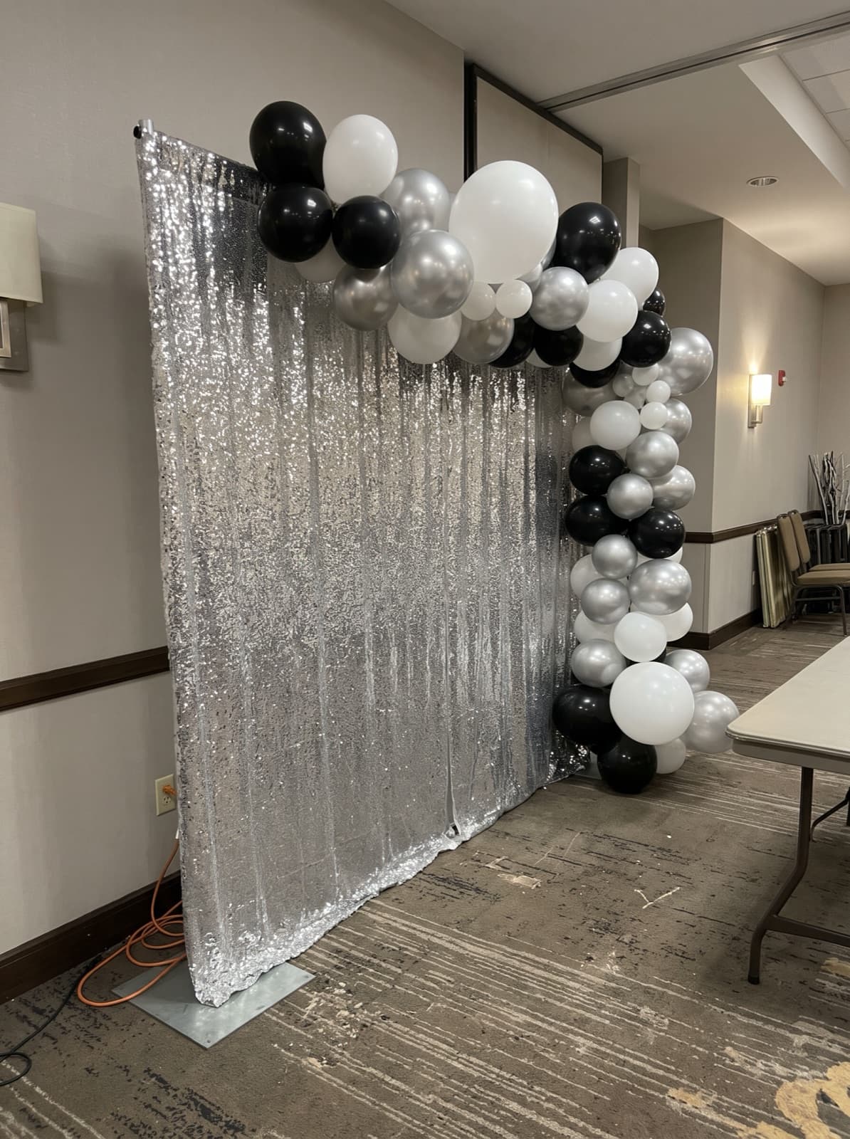 Silver shimmer wall backdrop with a balloon garland