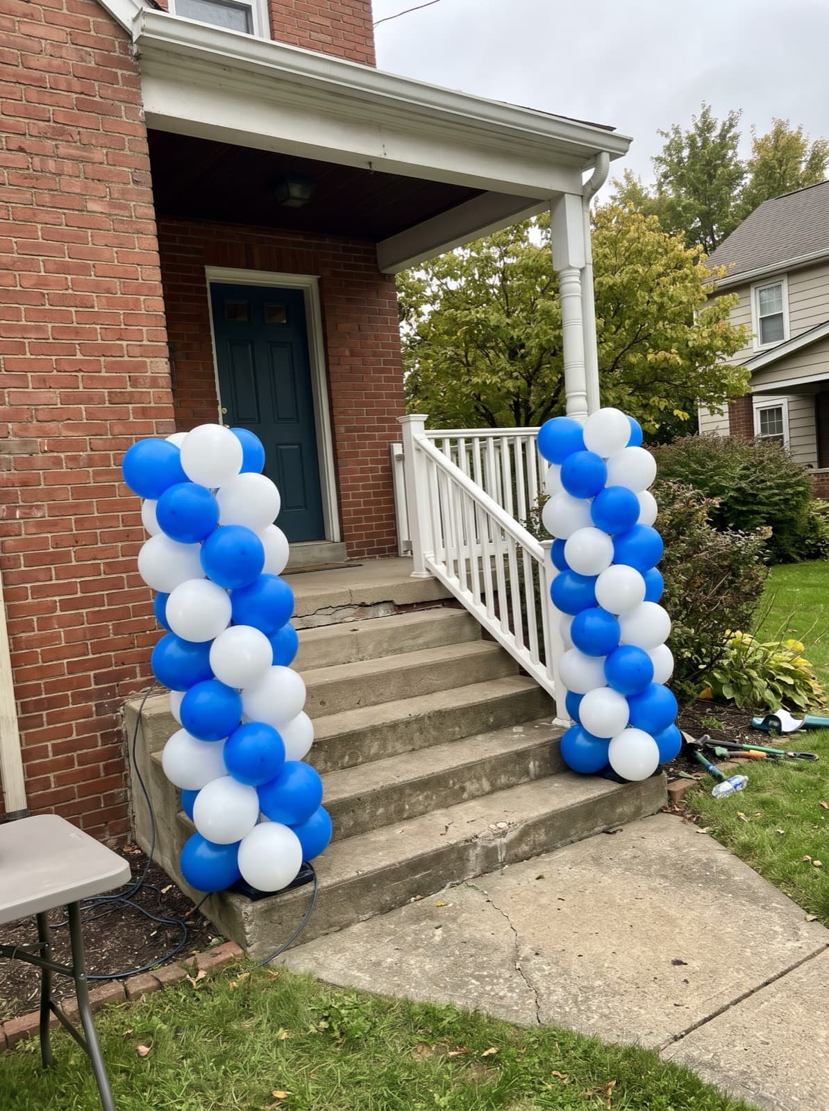Pair of spiral balloon columns at the foot of porch steps
