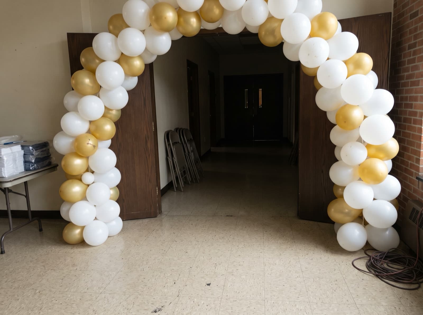 Balloon columns joined by an arch at a church hall entrance