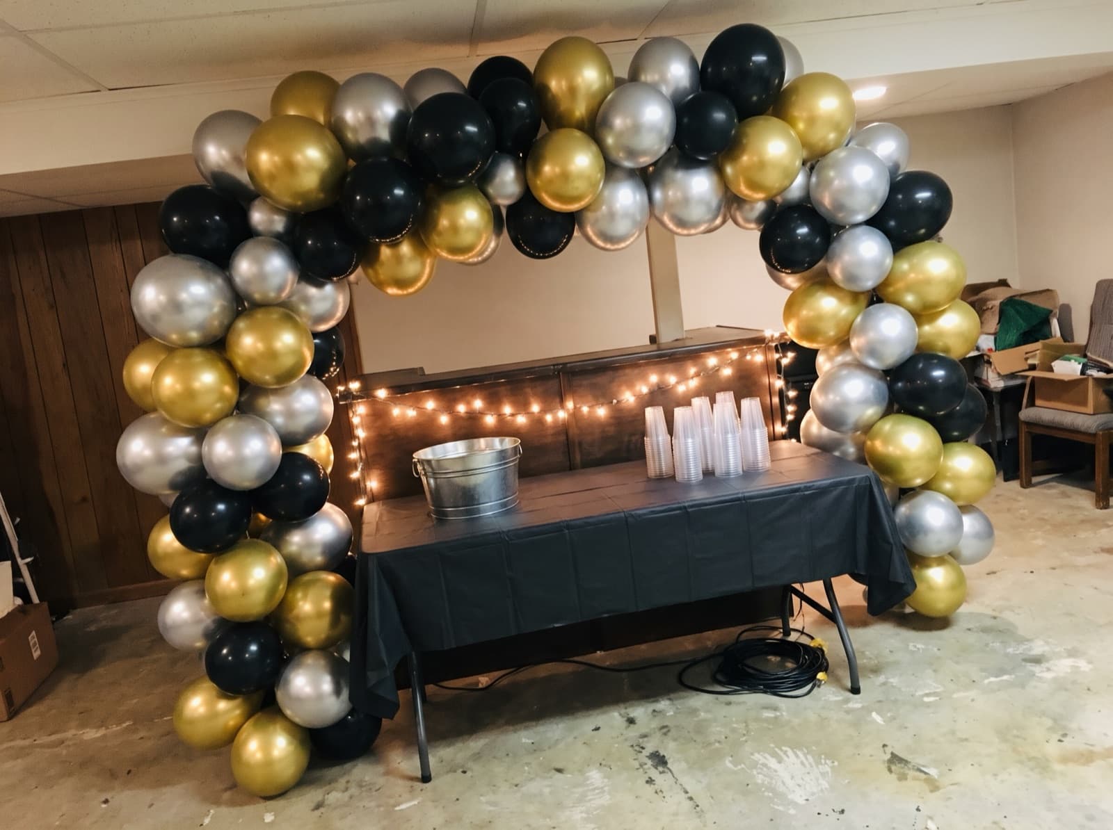 Chrome gold, silver and black garland over a basement bar
