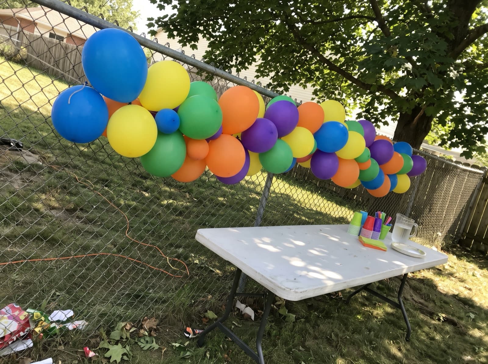 Grab-and-go balloon garland on a backyard fence