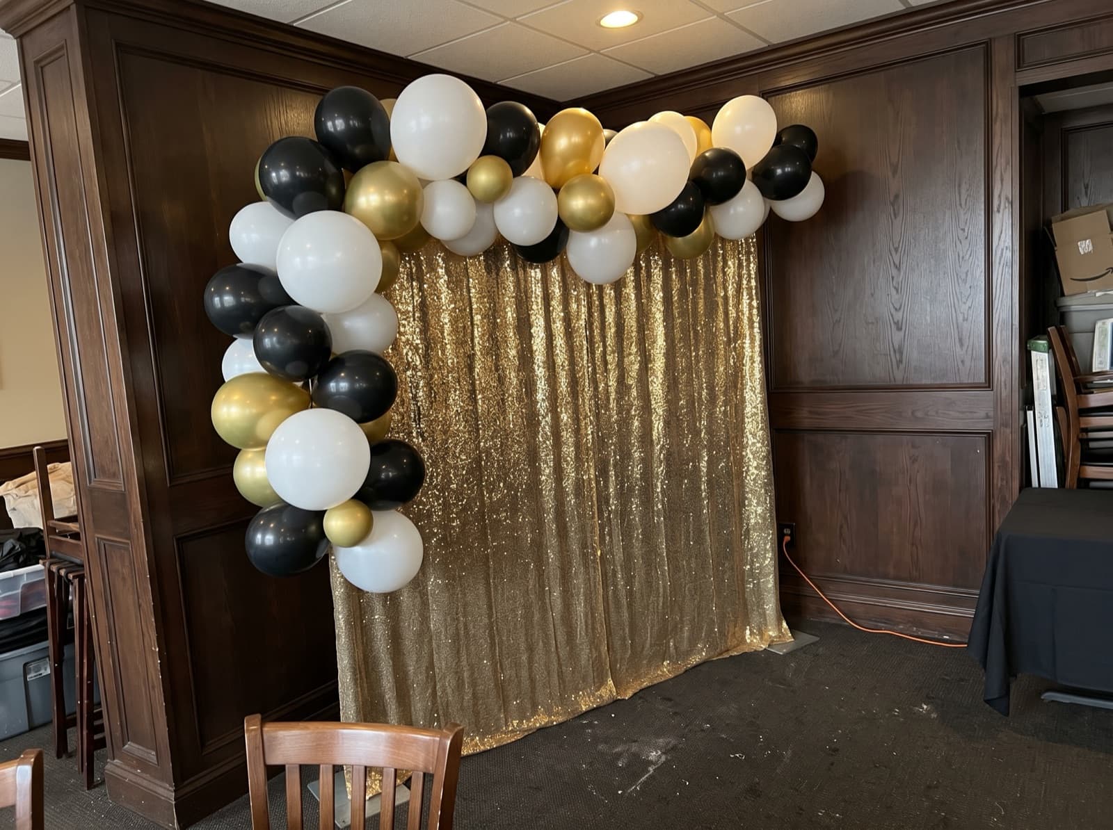 Balloon garland over a gold shimmer wall